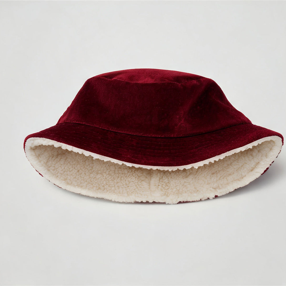 Robin Bucket Hat showing the cream sherpa lining under the burgundy velvet brim