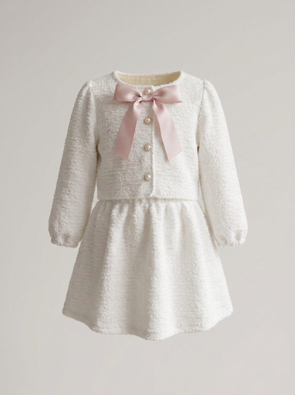 Bouclé Bow Set — cropped bouclé jacket with pearl buttons and a pink satin bow, with matching bouclé skirt