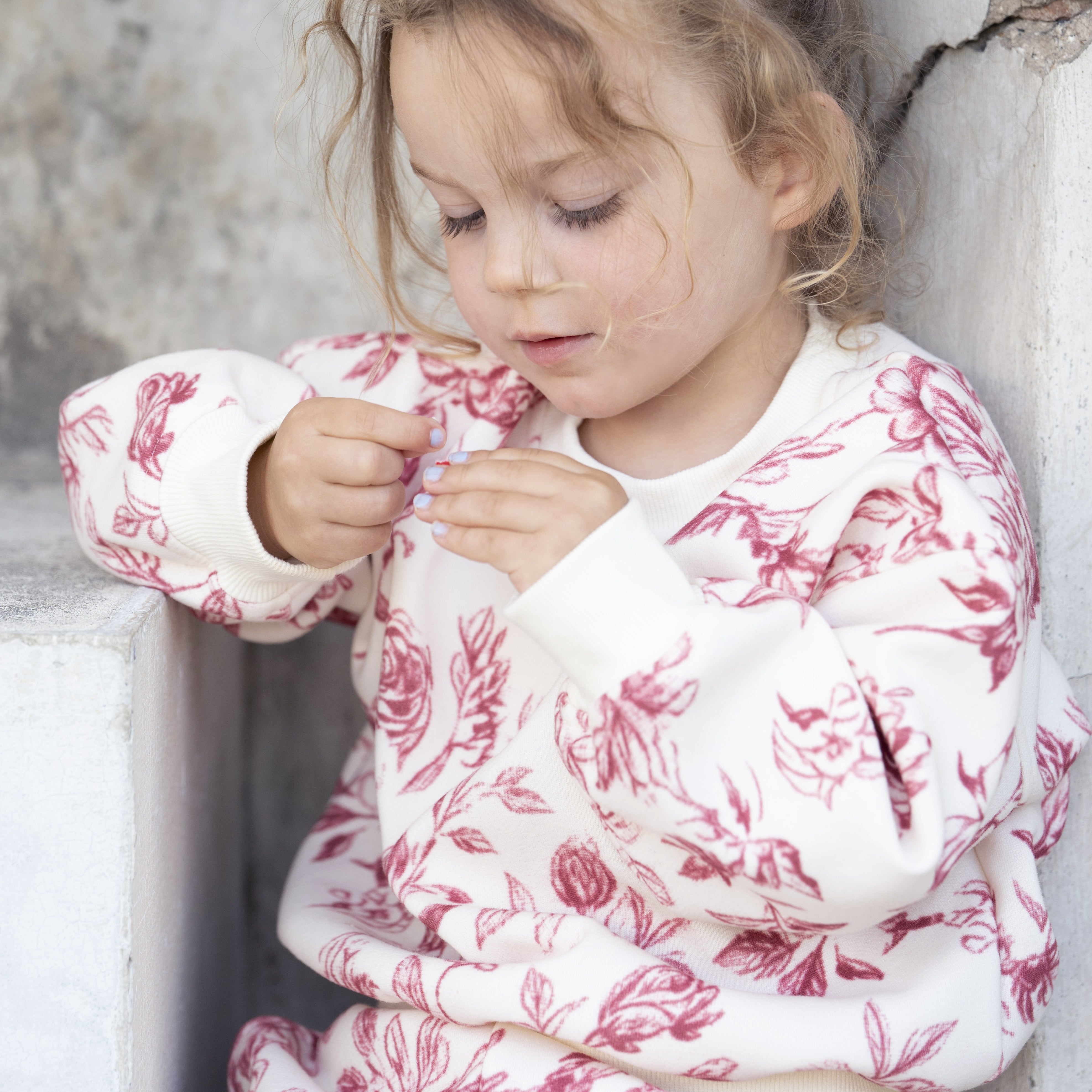Rose Tracksuit — close up of burgundy rose print on cream fleece (square)