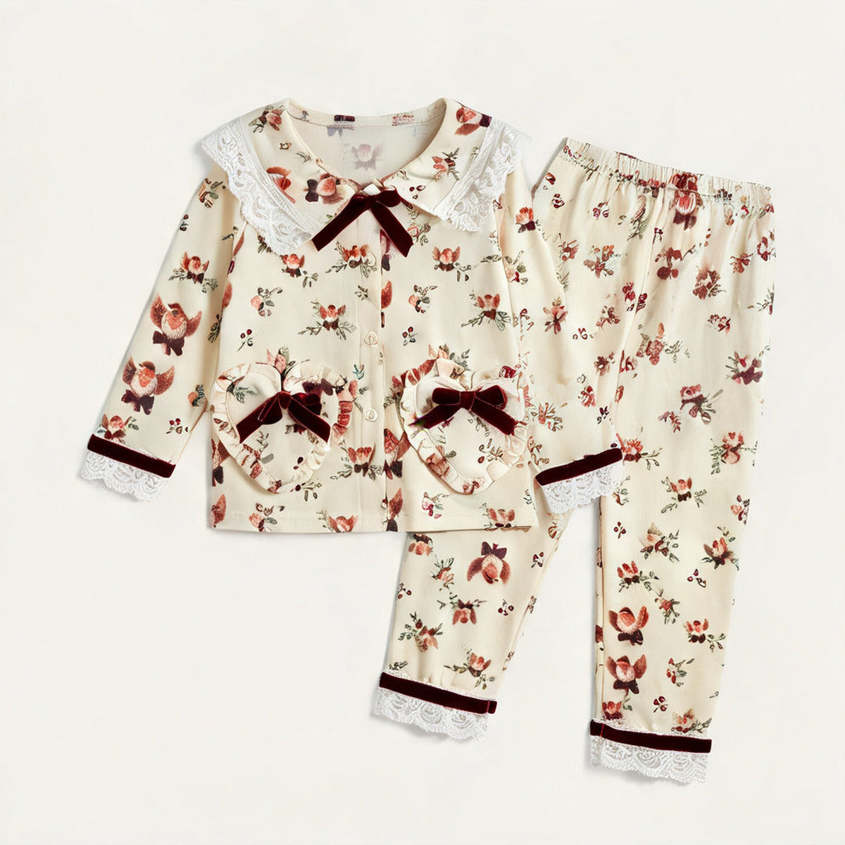 Christmas Pyjamas laid flat, top and bottoms in the cream robin and rosebud print